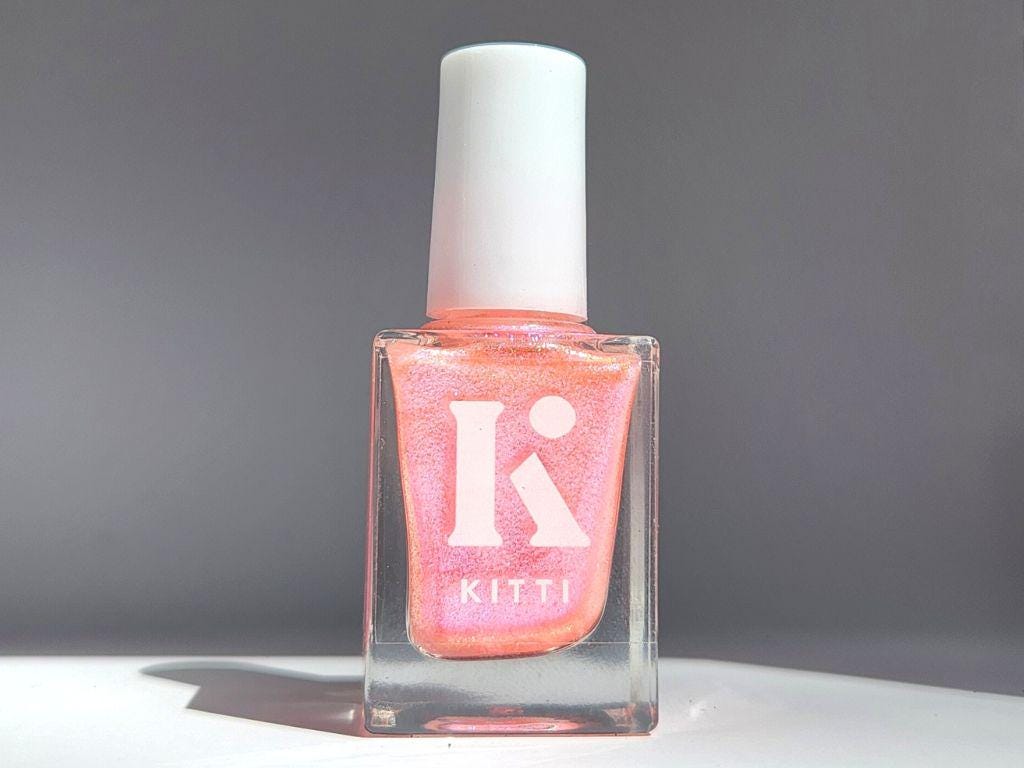 Glow Up bottle shot – sheer coral peach nail polish with shimmering shift