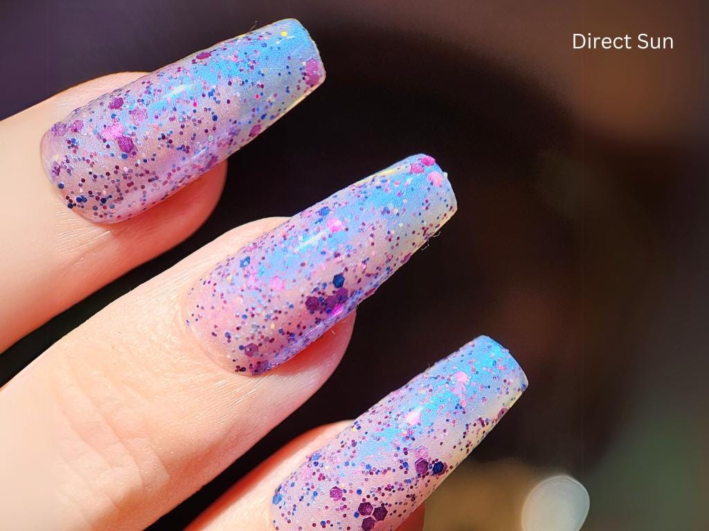 Macro shot of Barbie @ Bondi – blue & purple holographic glitter polish