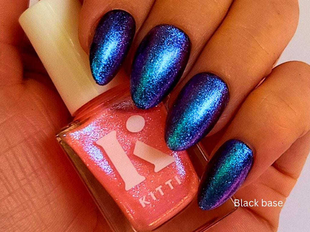 Glow Up over black nail polish – sheer peach with vibrant blue-purple shimmer pop