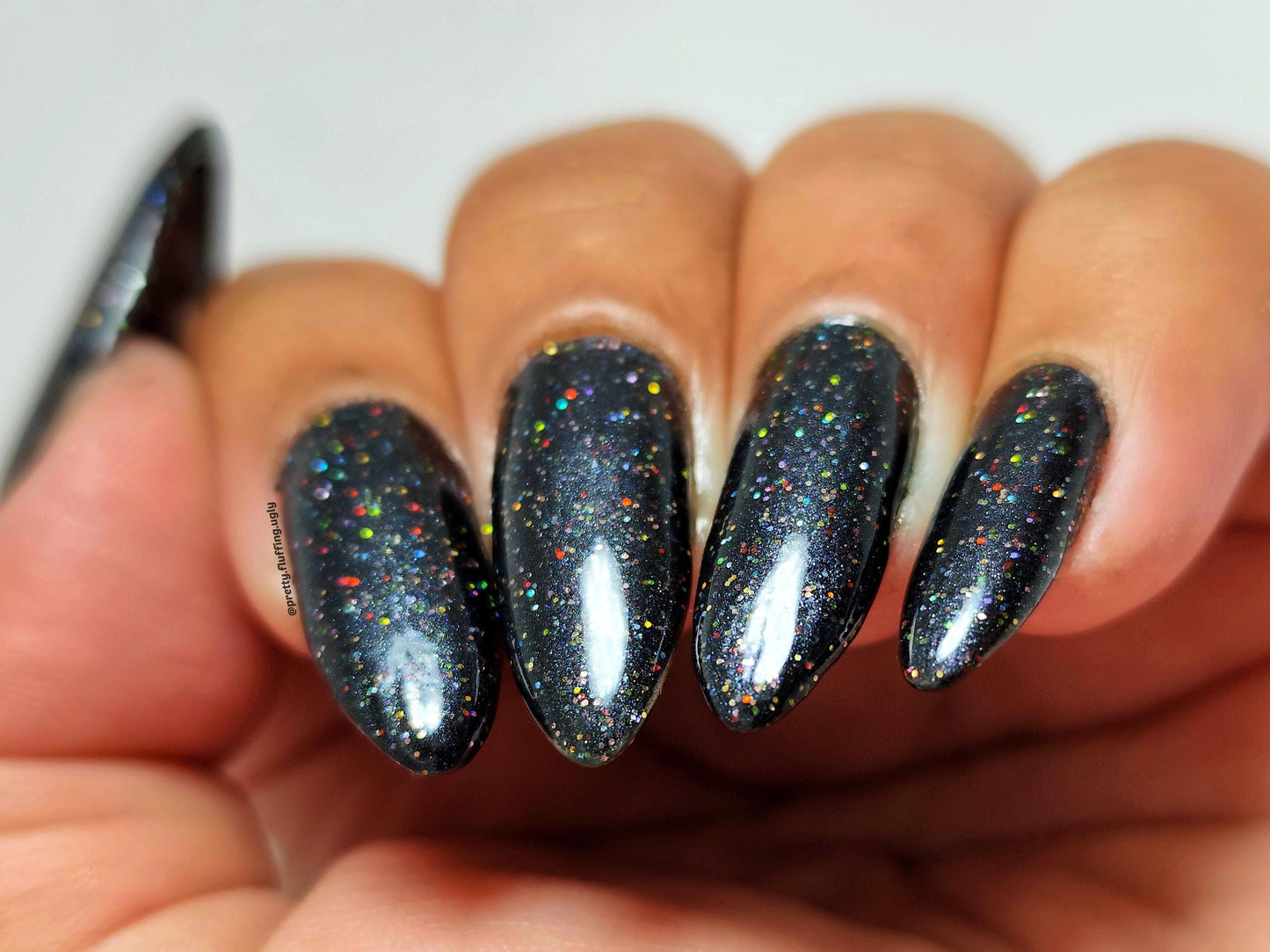 Black shimmer polish with rainbow holo on deep skin tone – Kitti Nails