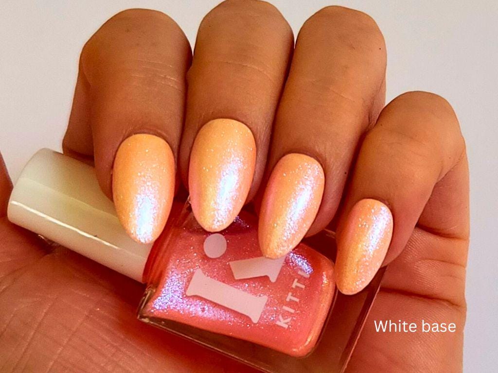 Glow Up over white polish – shimmer topper with peach tint and cool tone shimmer