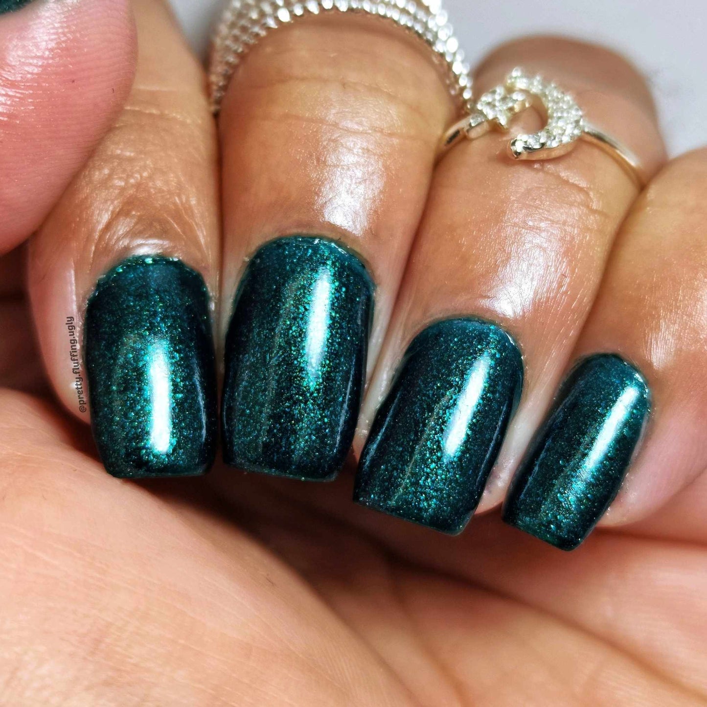 Dark Green polish on deep skin tone