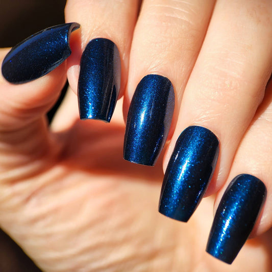 Midnight Brew nail polish bottle with glowing blue shimmer