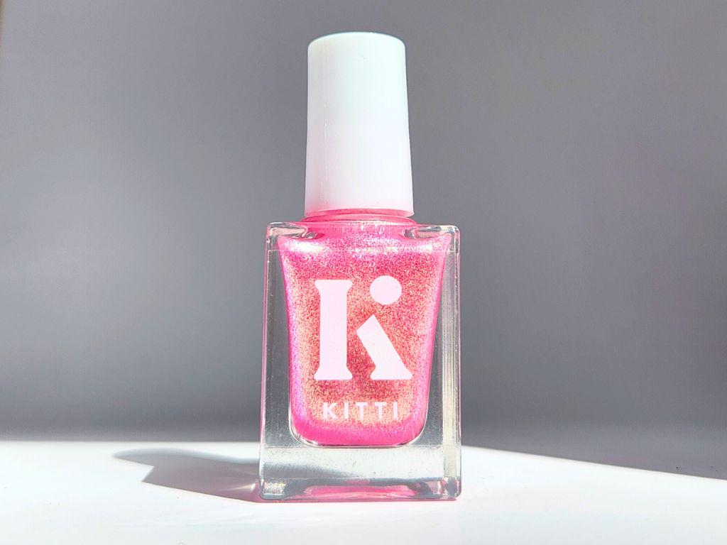 Bottle of Glow Hard or Go Home – sheer pink shimmer nail polish with gold-green glow