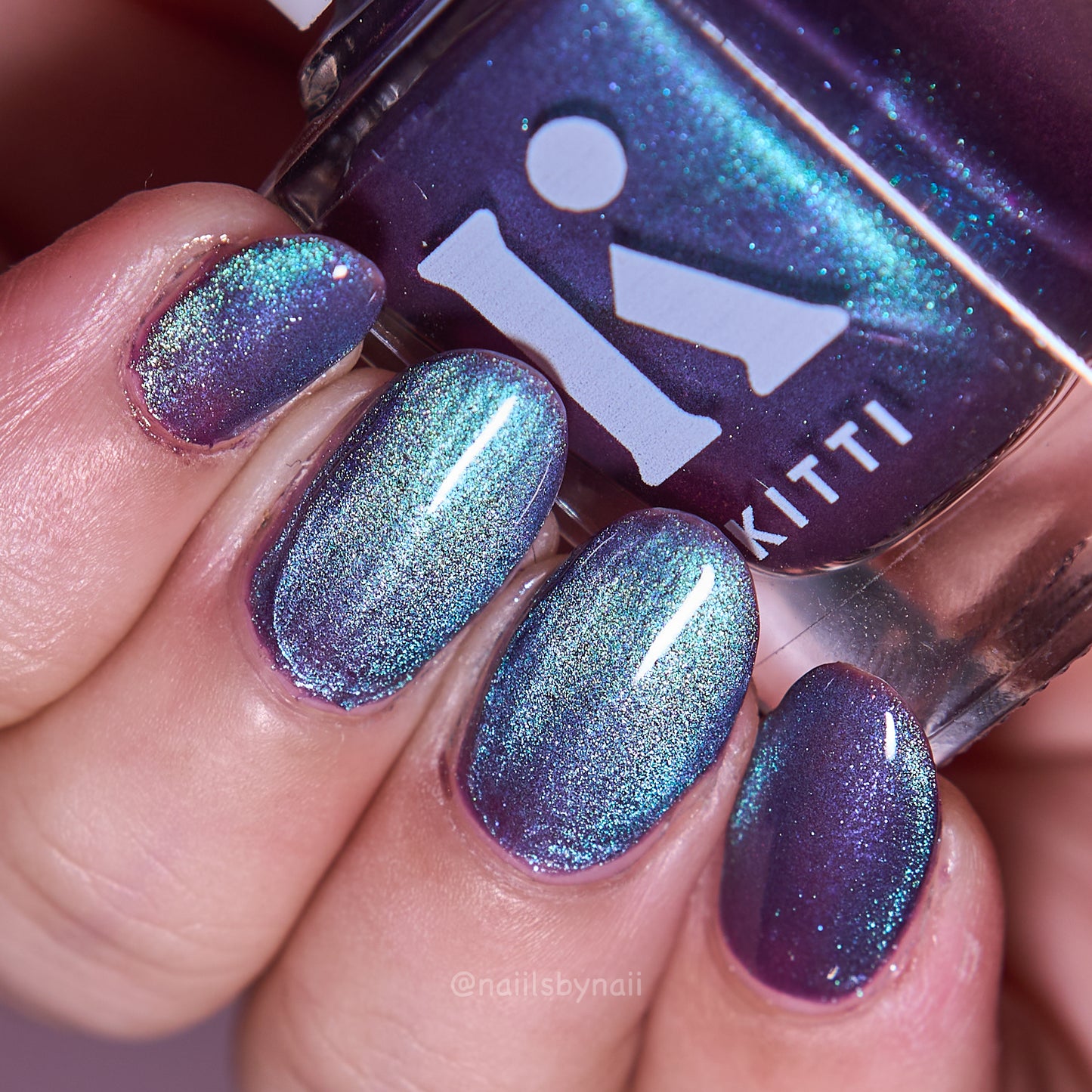 Witch themed magnetic nail polish swatch for halloween. Purple and green glittery nail polish swatch