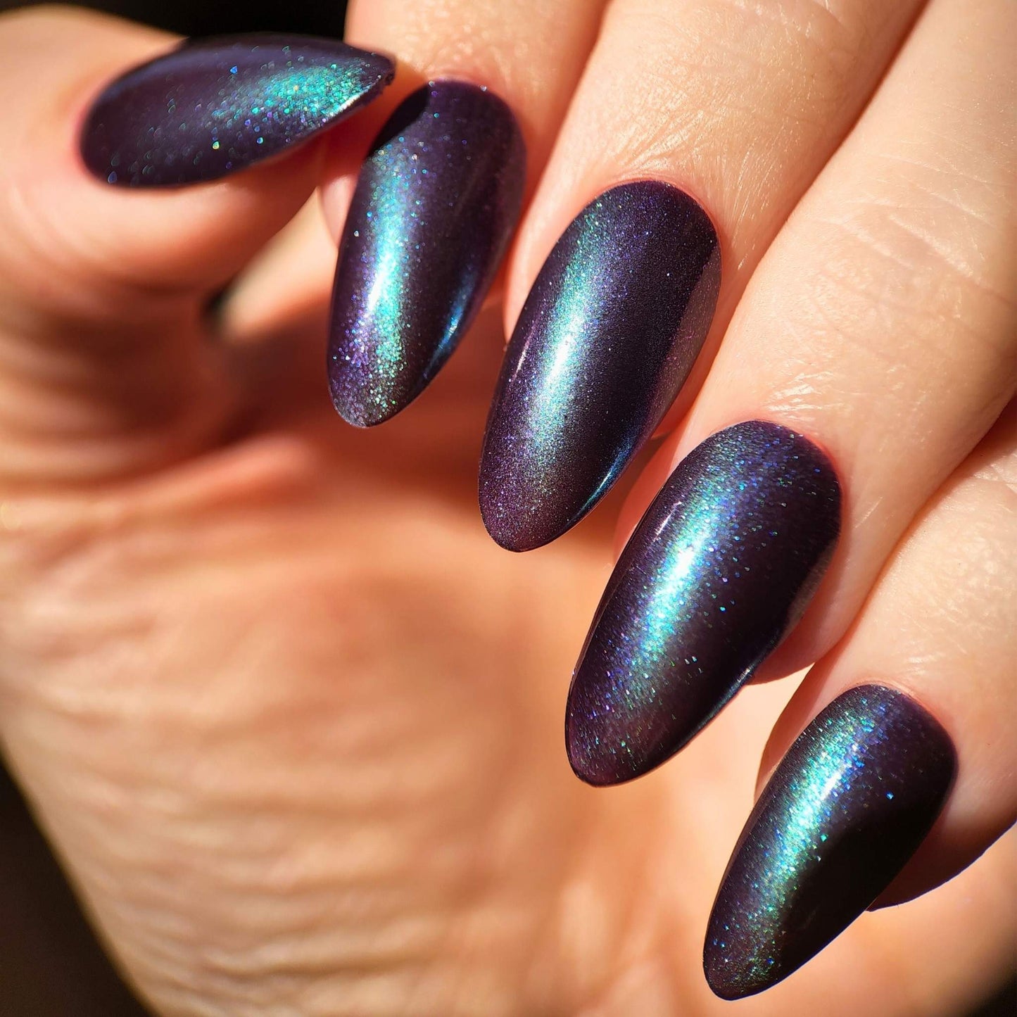 Purple cat eye polish with green line effect and shimmer