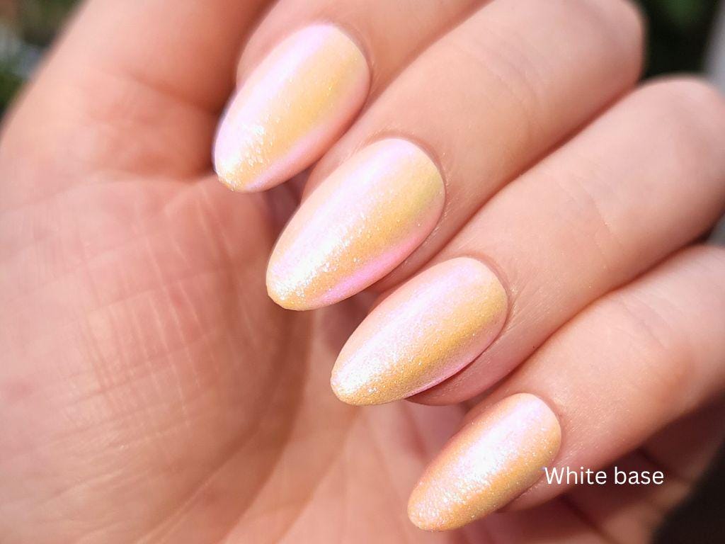 Cruelty-free shimmer topper over white base – peach polish with iridescent glow