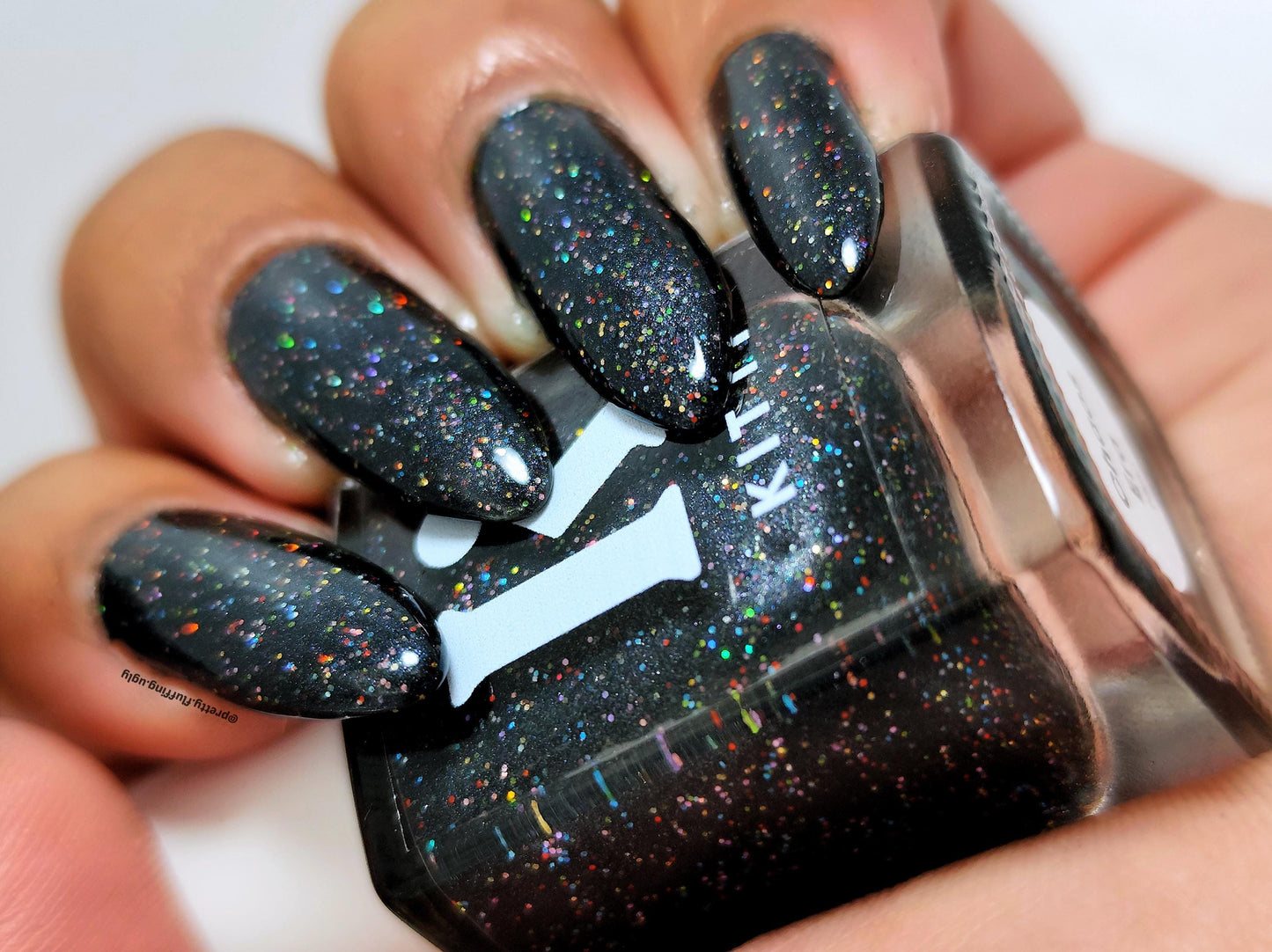 Macro swatch of Chaos Era – rainbow sparkle on black base