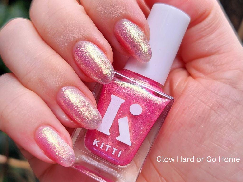Bottle of Glow Hard or Go Home – sheer pink shimmer nail polish with gold-green glow
