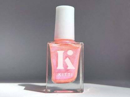 Glow Up bottle shot – sheer coral peach nail polish with shimmering shift