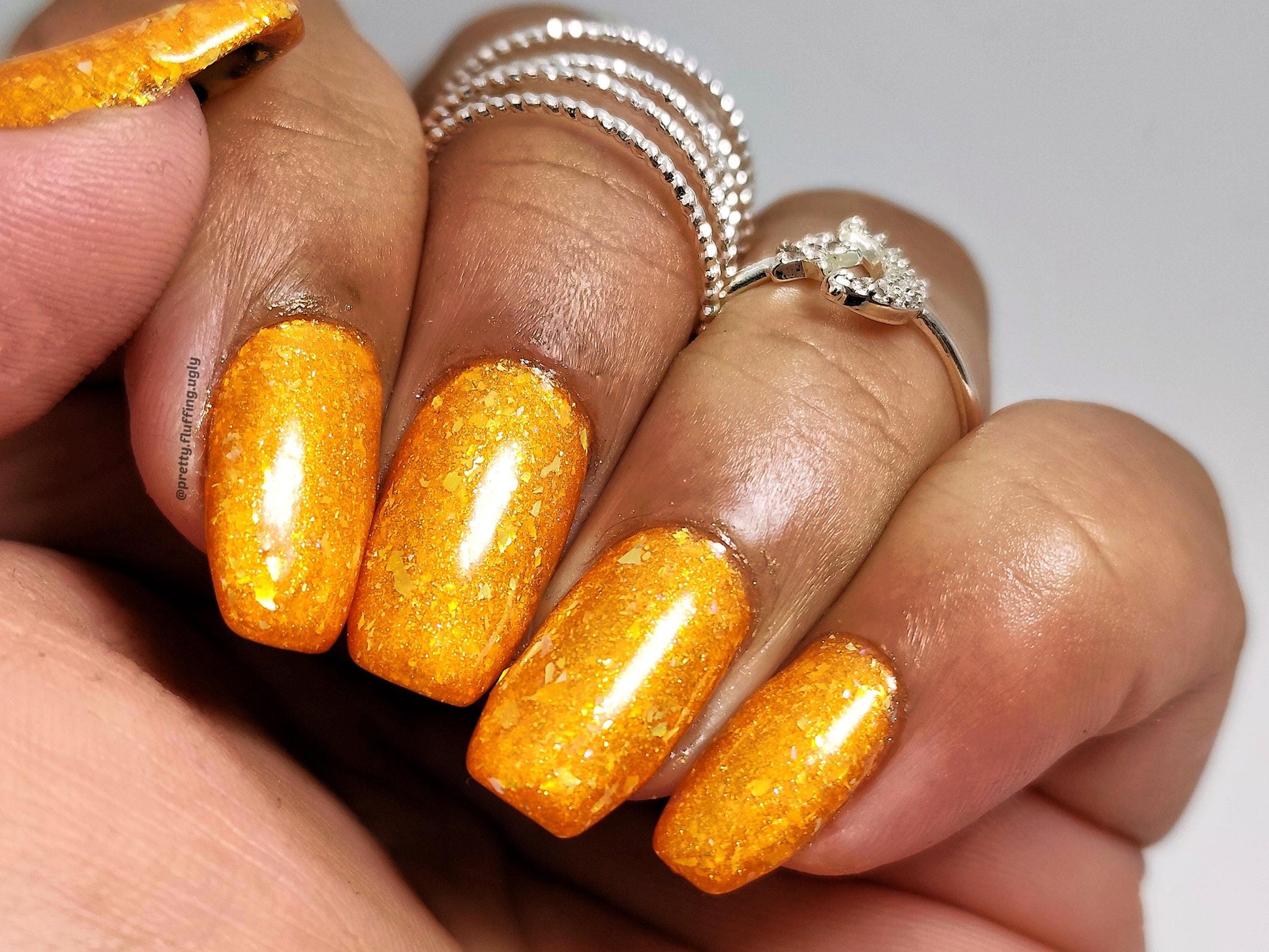 Iridescent gold flake polish in jelly base – warm tone nail art