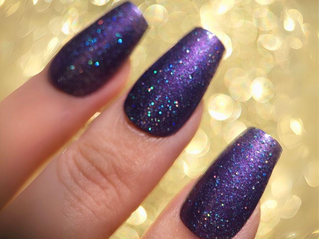 Close-up of Unhinged After Dark – turquoise holo sparkle on deep purple base