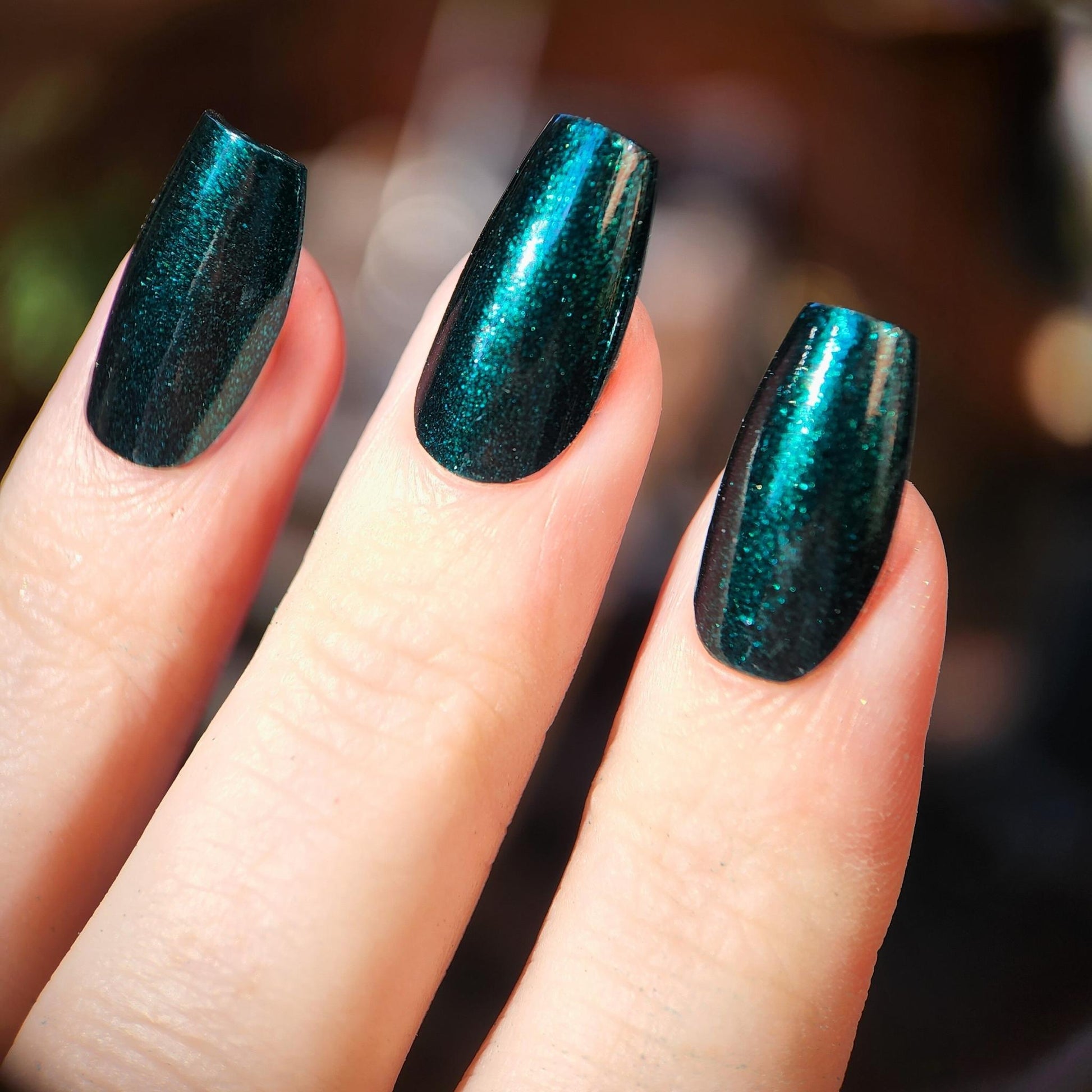 Glossy emerald green polish with glowy shimmer finish