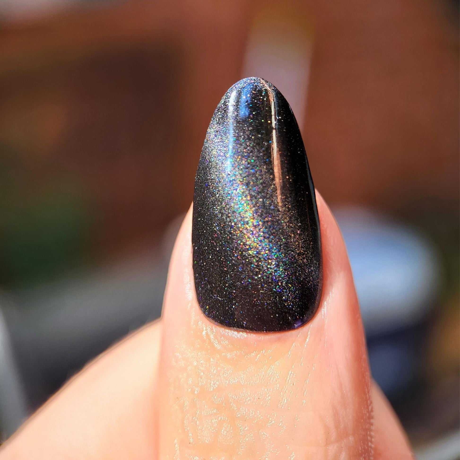 Witchy magnetic nail polish with holographic sparkle on nails