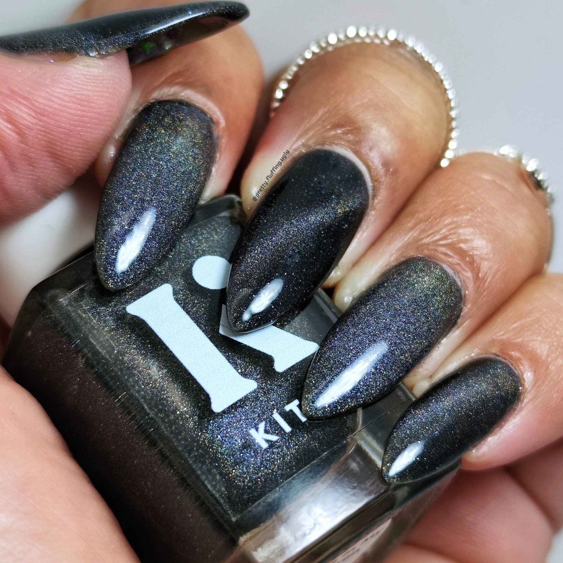Non-toxic magnetic polish with cat eye rainbow effect on dark skin tone