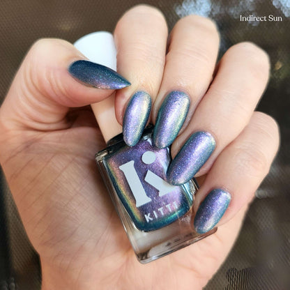 Close-up of nails painted with Hex & The City – blue to purple holographic shimmer