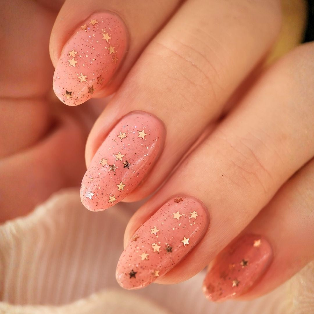 Close-up of Champagne Popper topper showing rose gold mini star glitter with holographic and reflective sparkle