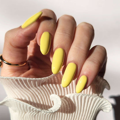 Close-up of nails painted with No Thoughts, Just Sunshine – glossy buttery yellow polish
