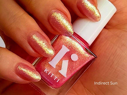 Subtle shimmer polish with green-gold shift – light skin tone swatch