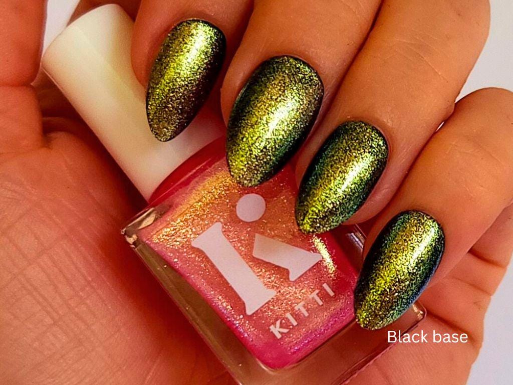 Pink shimmer polish with gold and green shift used as a topper over black base– Glow Hard or Go Home
