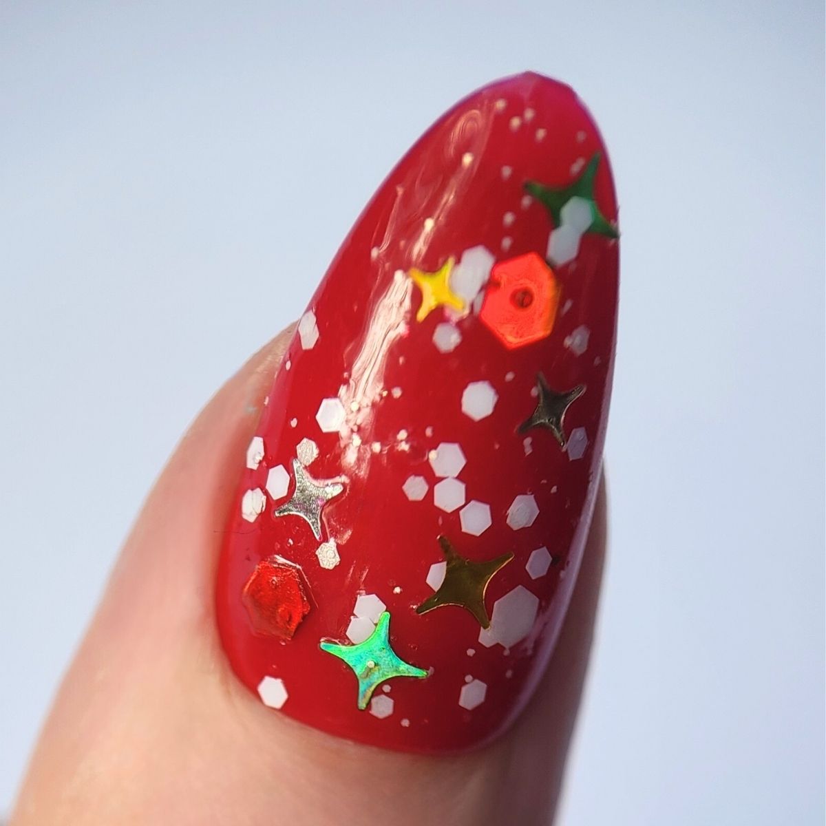 Close up image of red nail with christmas nail art