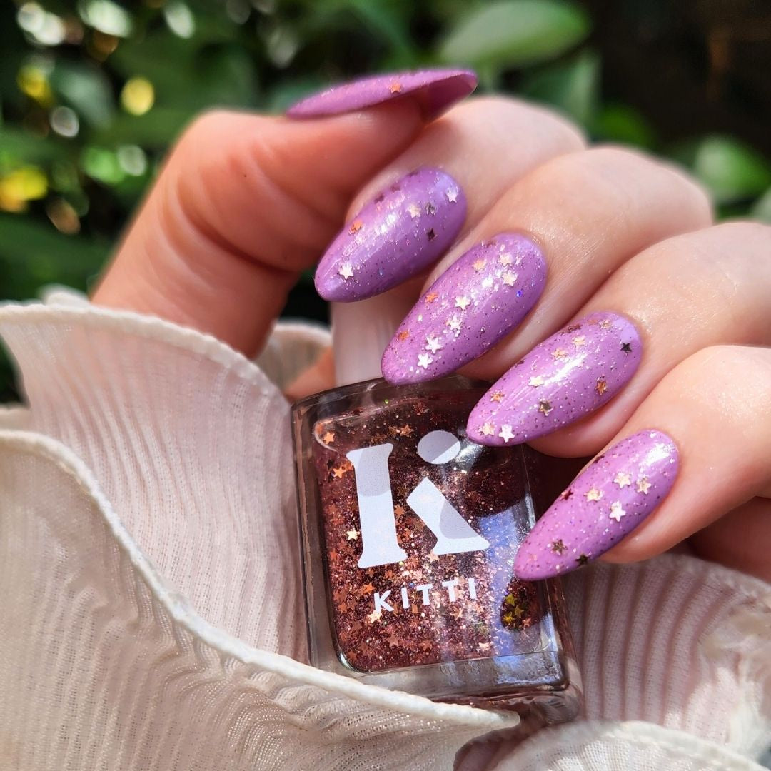 Champagne Popper glitter topper over Lavender Haze purple nail polish with holo and reflective glitter mix