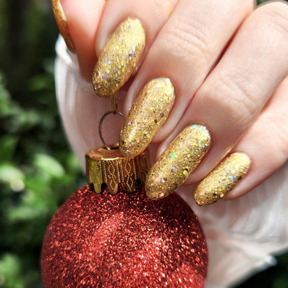 Red glittery christmas ornament with gold glittery nail design