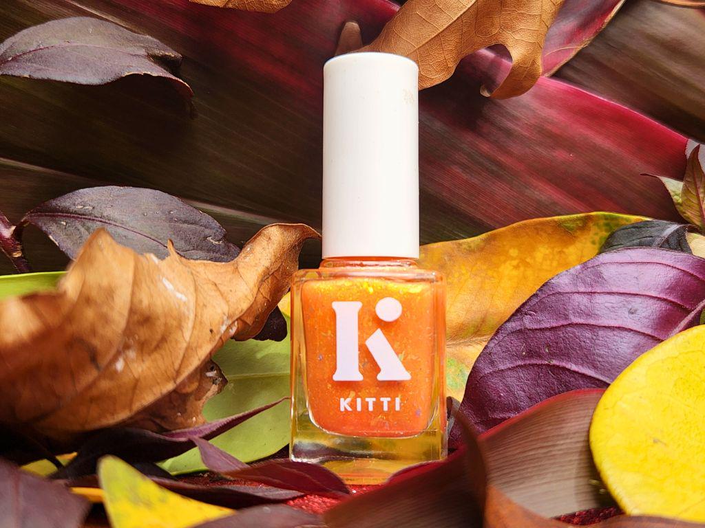 Kitti Nails orange jelly polish in bottle – glowing flake finish