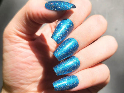 Deep navy nail polish with gold holographic glitter– opaque in 2–3 coats