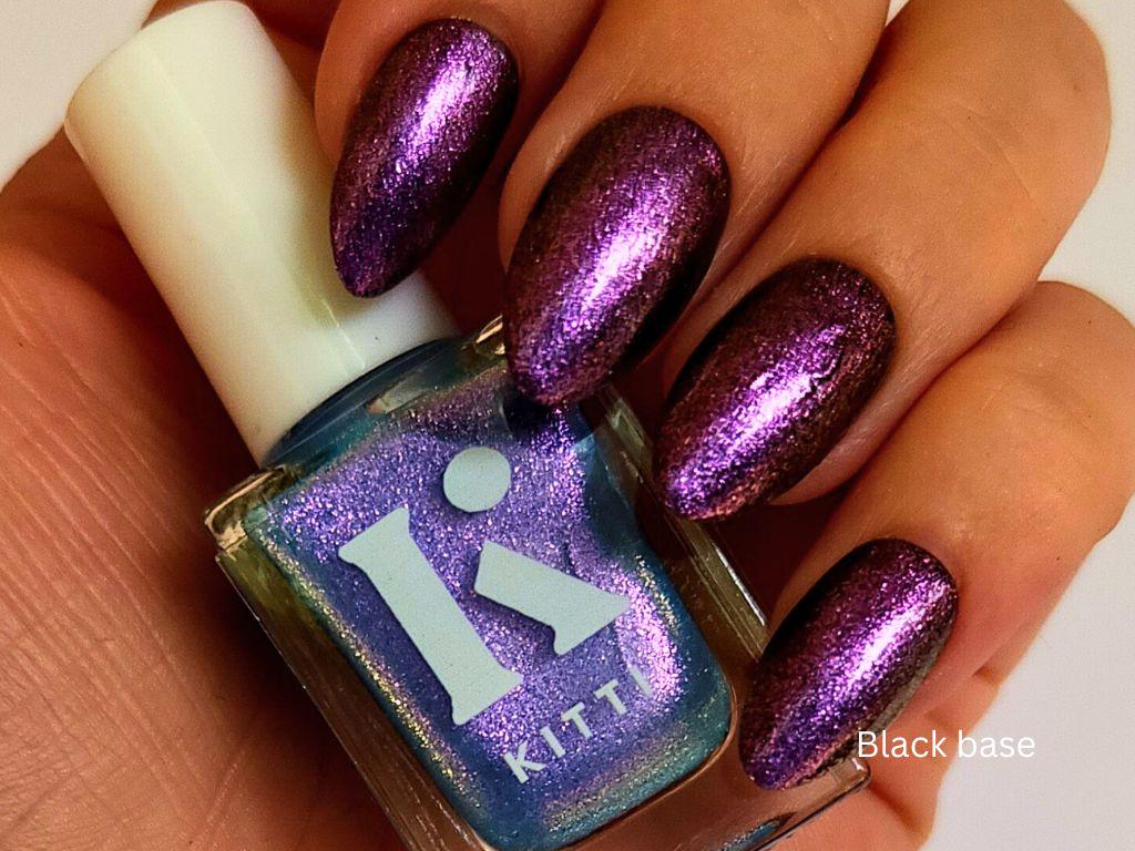 Glow & Tell layered over black – sheer blue base with strong purple shimmer shift