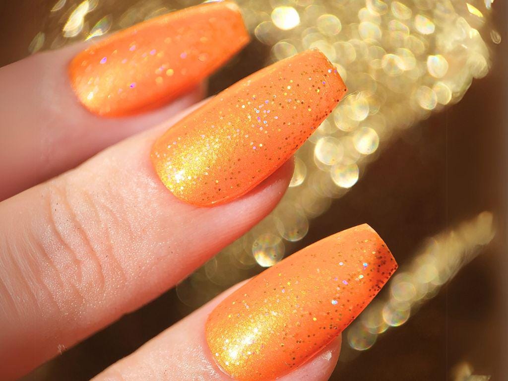 Close-up of glitter texture – cruelty-free vegan orange nail polish